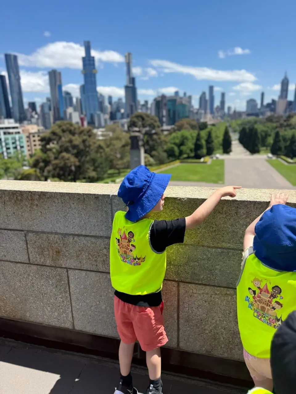 Children looking out over a city skyline during an excursion with Kids Kingdom.