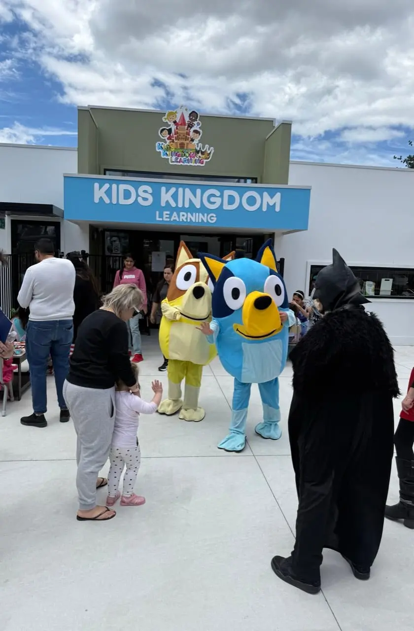 Children arriving together at a community excursion destination in high-visibility vests.