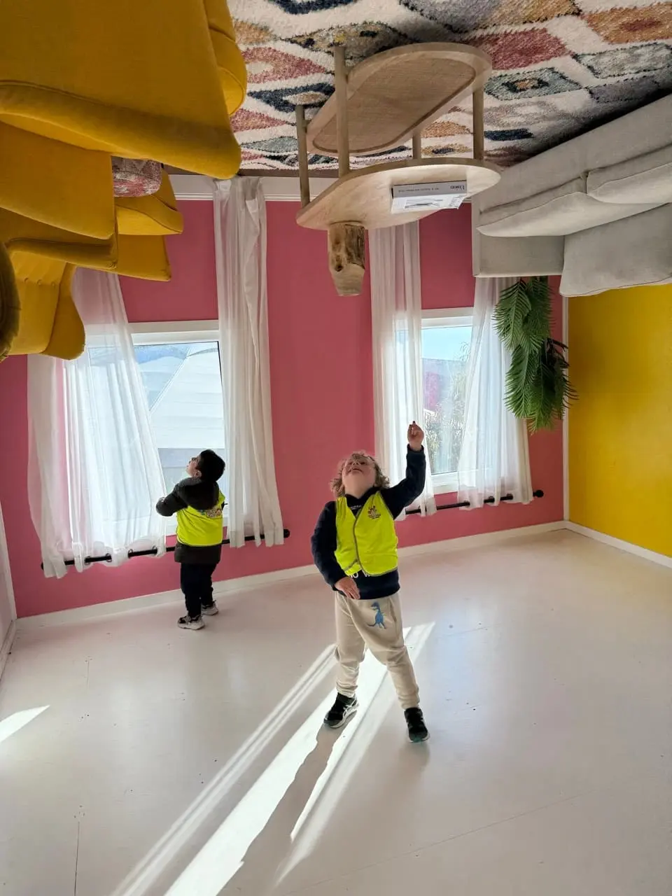 Children moving together through a centre hallway as part of a supervised transition.