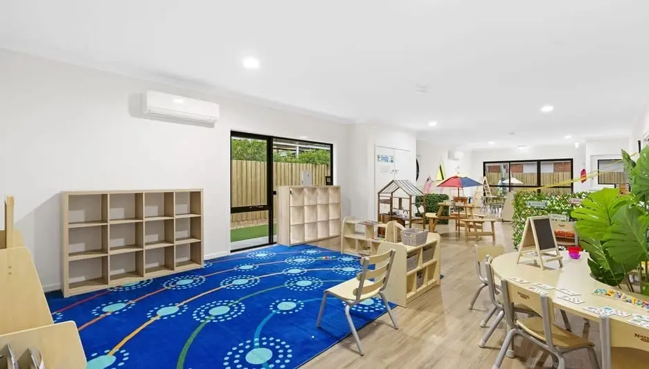 A blue rug group area in the Hoppers Crossing classroom arranged for circle time and play.