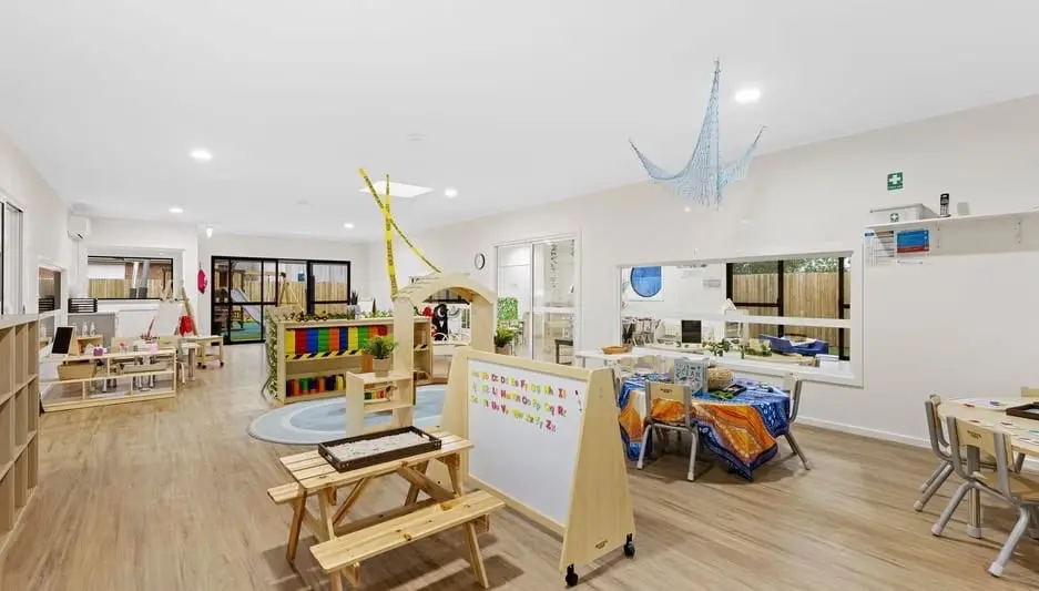 A light-filled learning studio with soft furnishings and open activity areas at Hoppers Crossing.