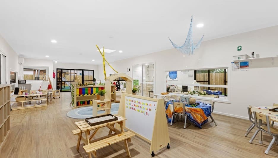 A light-filled learning studio with soft furnishings and open activity areas at Hoppers Crossing.