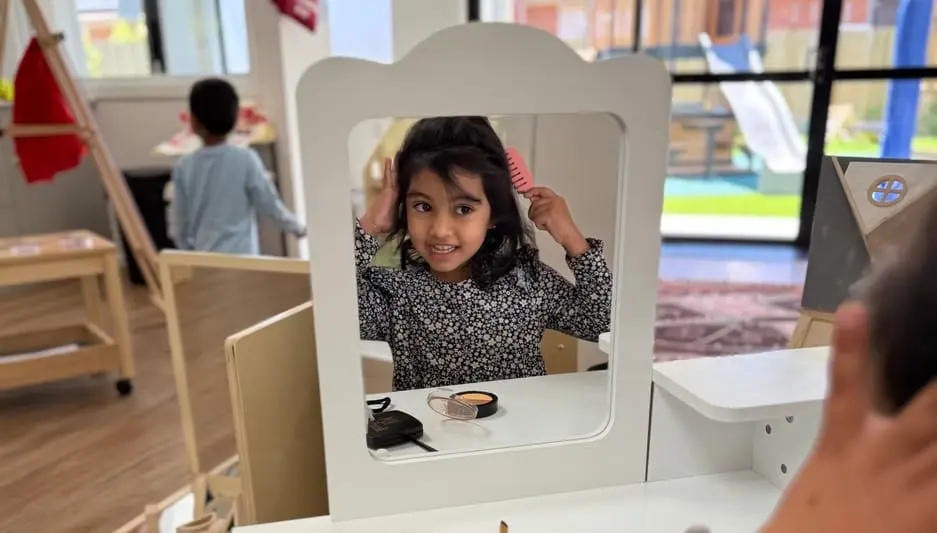 A child exploring a mirror play setup inside the Hoppers Crossing centre.